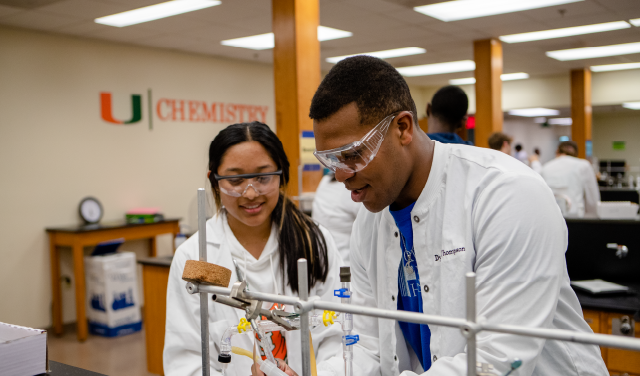 Two students collaborate in a chemistry class.